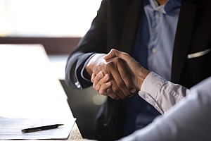 a CPA shaking hands with a business owner after preparing taxes