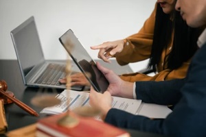 asian man and woman collaborating professional setting, law office