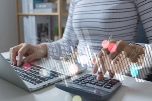 businesswomen using the laptop computer and calculator tax online return form for payment