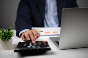 businessman uses a calculator to perform financial calculations or budget planning