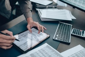 investors working on desk office and use tablet to check tracking cost