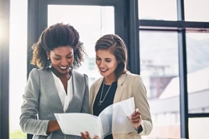women and discussion in office with file for teamwork