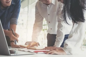 accountant discussing with partner are meeting to audit finance planning sales to meet targets set in next year