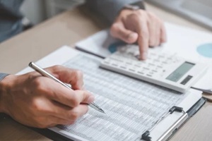 accountant used a calculator financial analysis managing payroll tax accounting budget accounts